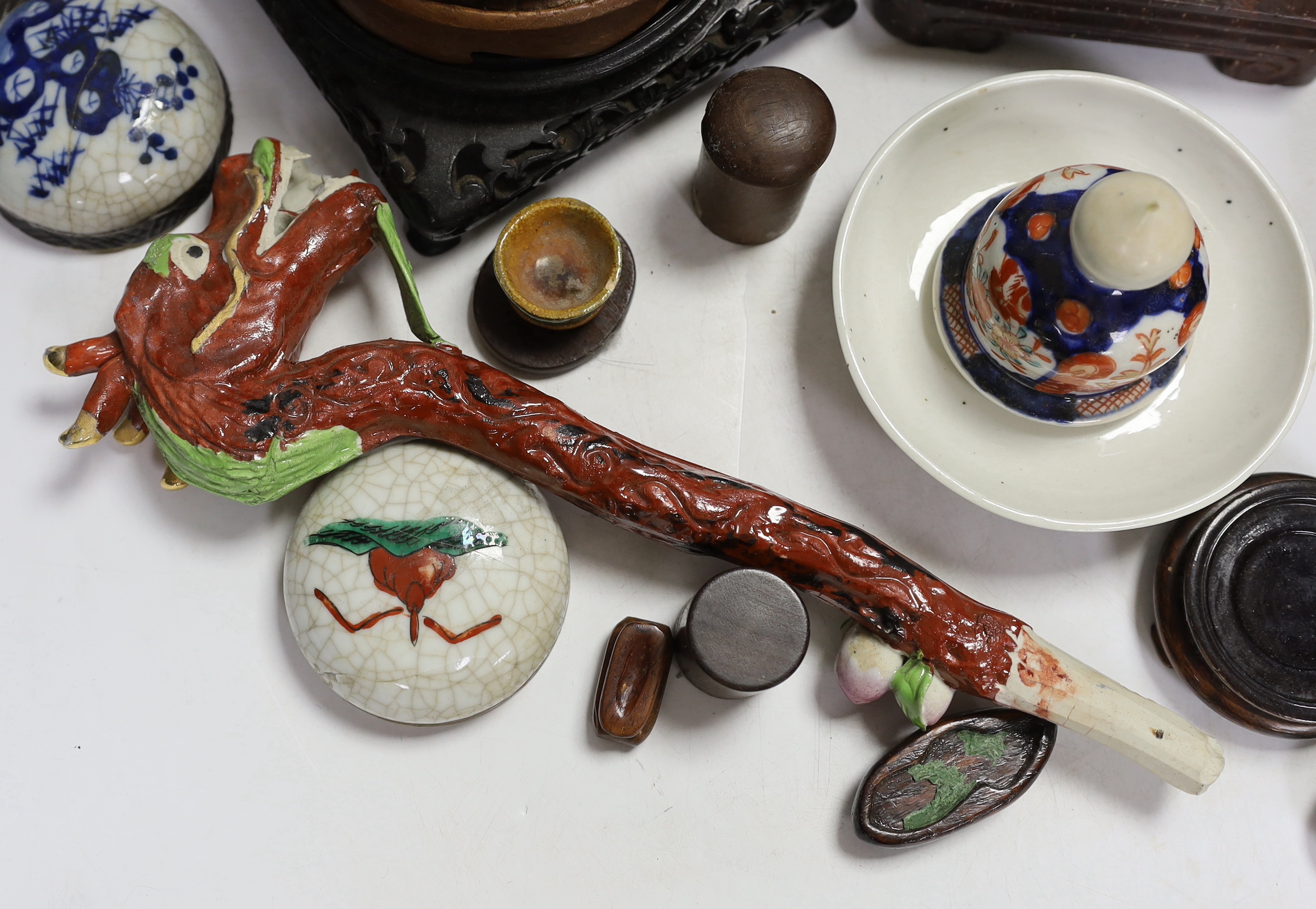 A collection of mixed Chinese wooden stands, a ceramic dragon head and miscellaneous ceramics